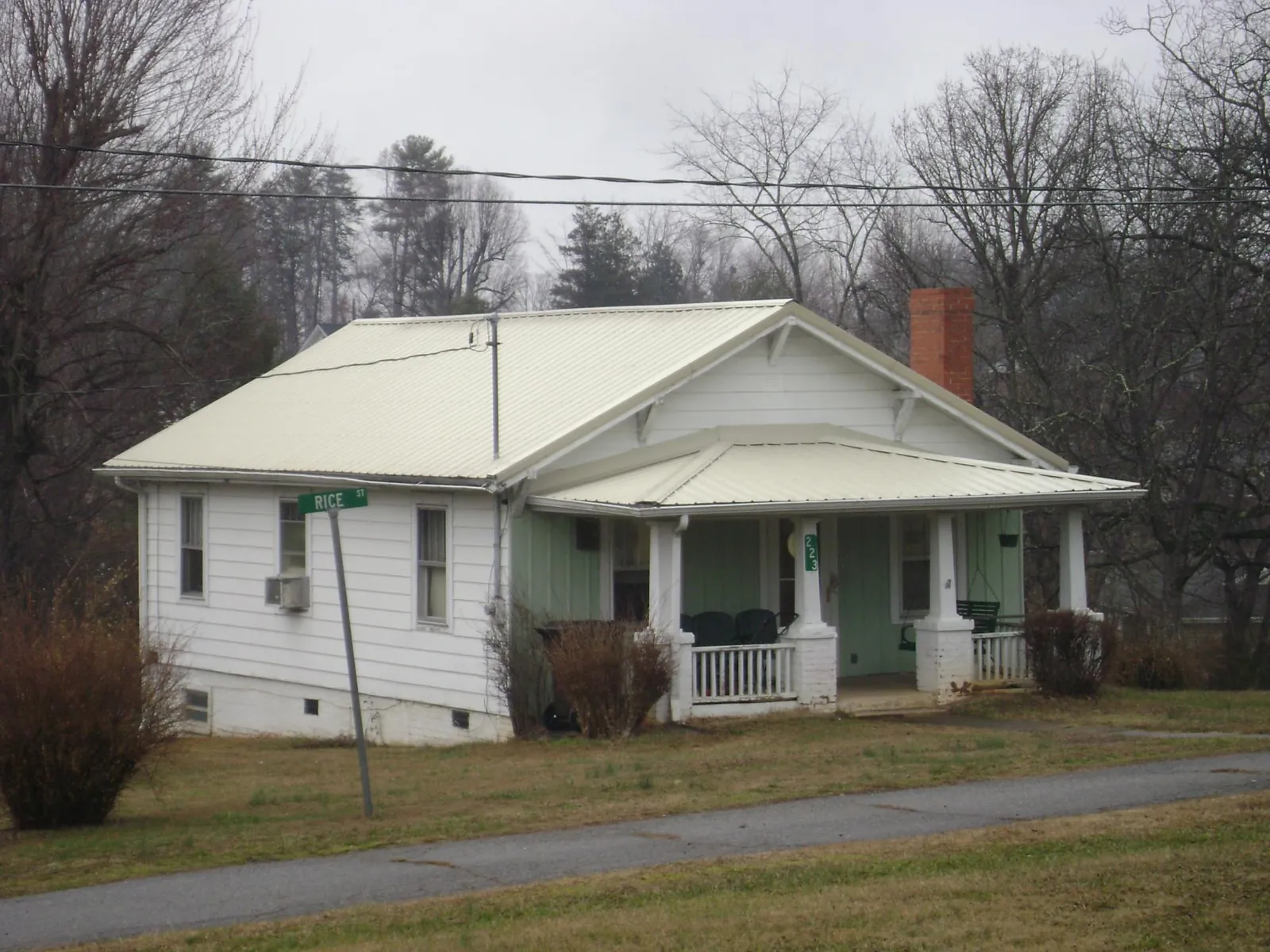 White metal roof on a craftsman bungalow at a street corner in Zumbrota