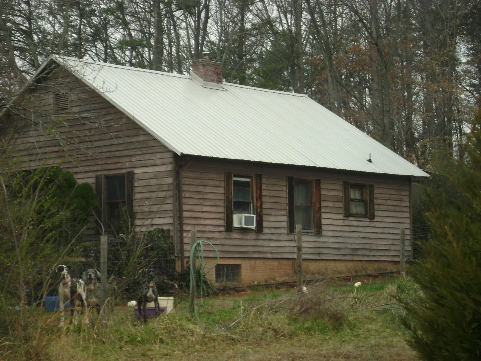 White metal roof on an old wood sided farmhouse, from a Metal Roof Installation job in Zumbrota